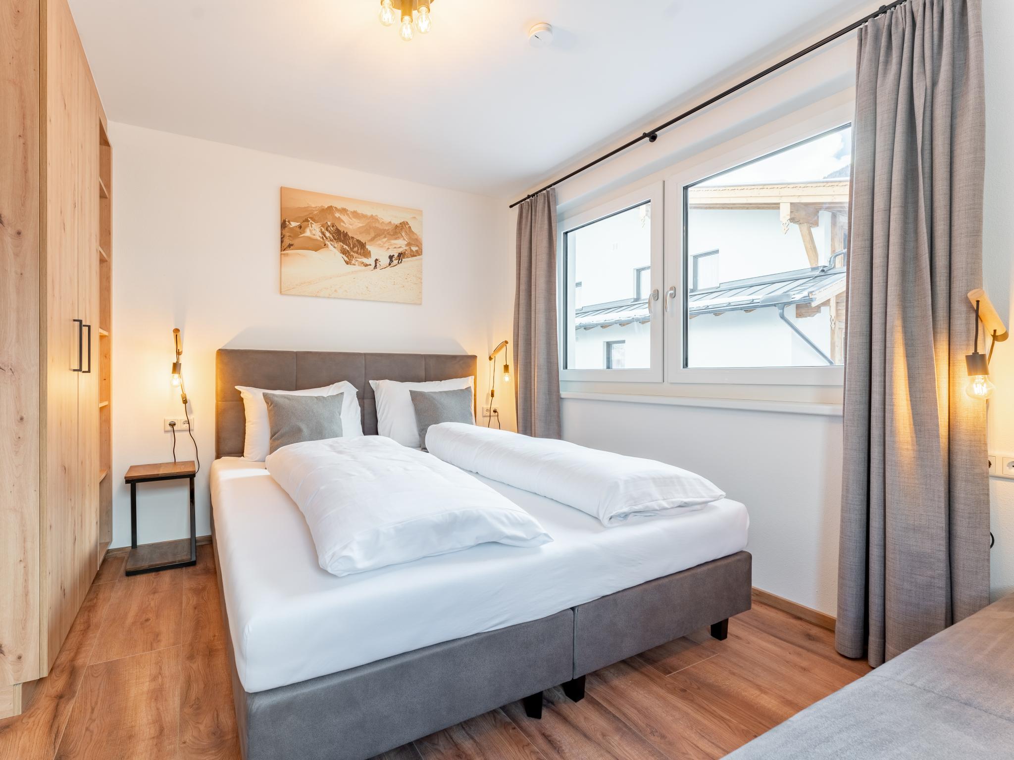 Bedroom with comfortable beds at Falken Suites TOP 3 in Kaprun