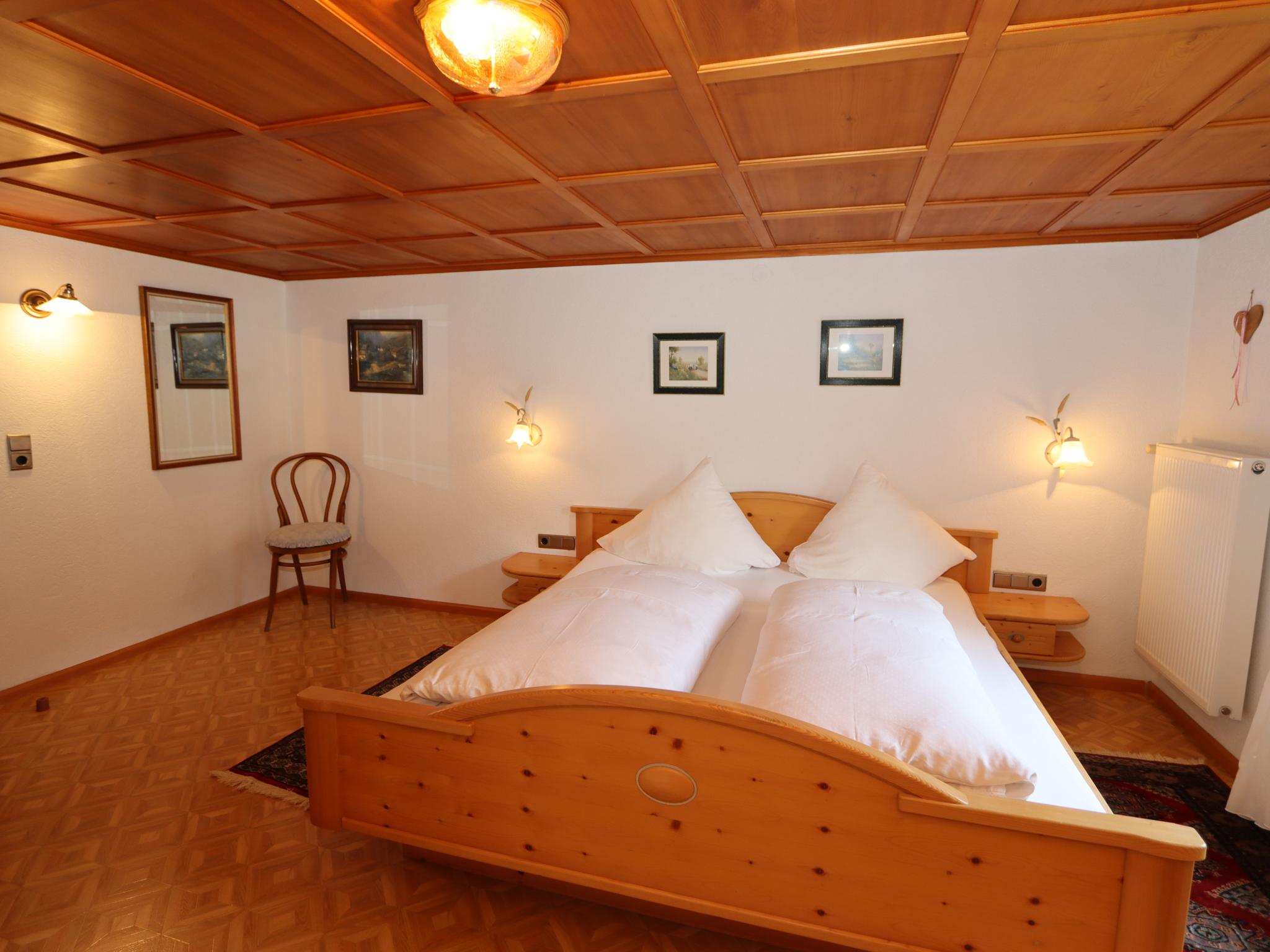 Bedroom with comfortable beds at Enzianhof in Silbertal