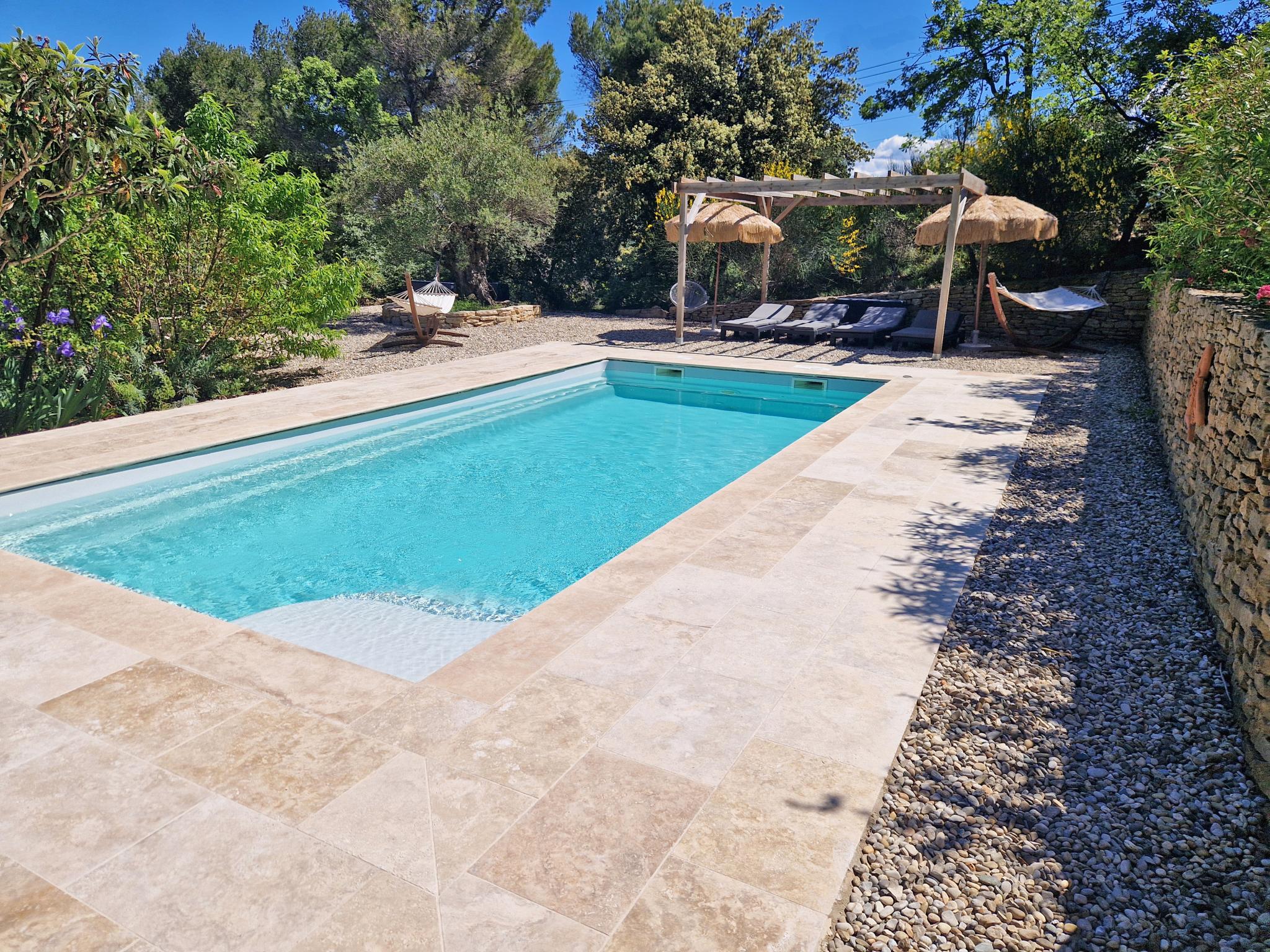 Swimming pool area at La petite Pinede in Faucon