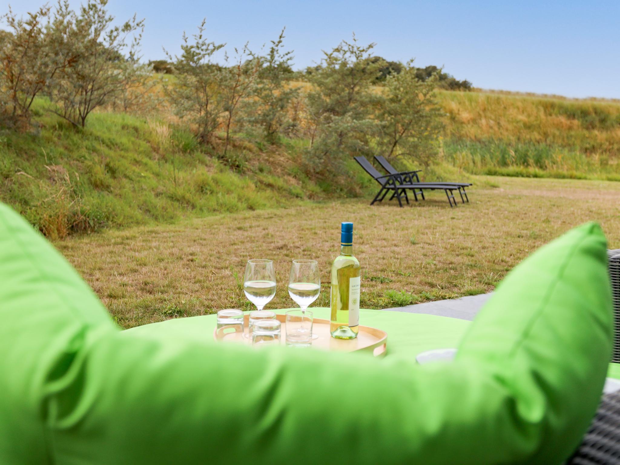 Outdoor terrace and views at Duinvallei Lodge Zeeland in Kamperland